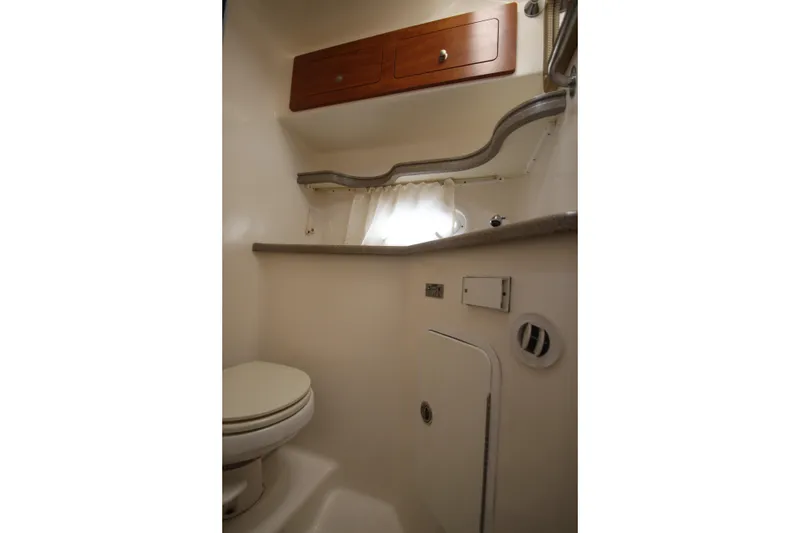 Slide: The Image of 2008 Rinker 330 Express Cruiser bathroom with toilet, storage cabinets, and compact design. - 31