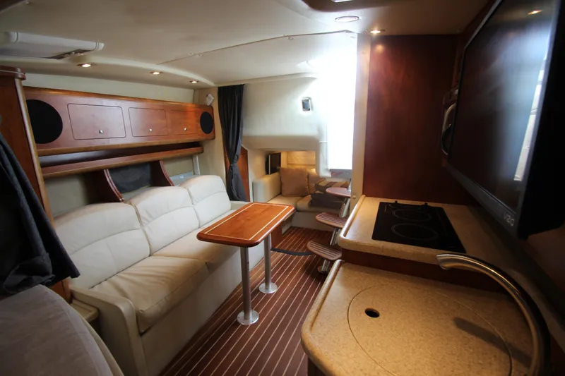 Slide: The Image of 2008 Rinker 330 Express Cruiser interior with cozy seating, kitchenette, and modern amenities. - 36