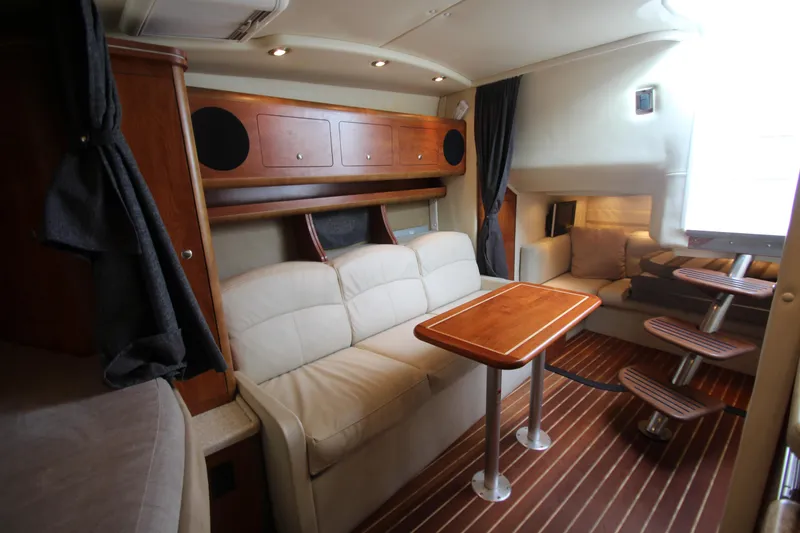 Slide: The Image of 2008 Rinker 330 Express Cruiser interior with cozy seating and wooden accents. - 38