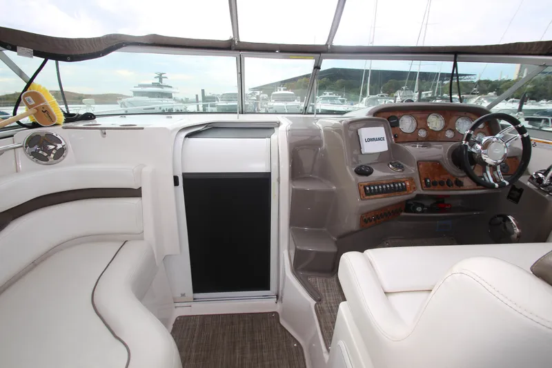 Slide: The Image of 2008 Rinker 330 Express Cruiser cockpit with steering wheel and navigation instruments. - 40