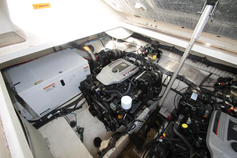 Slide: The Image of Engine compartment of 2008 Rinker 330 Express Cruiser with visible Kohler generator. - 44