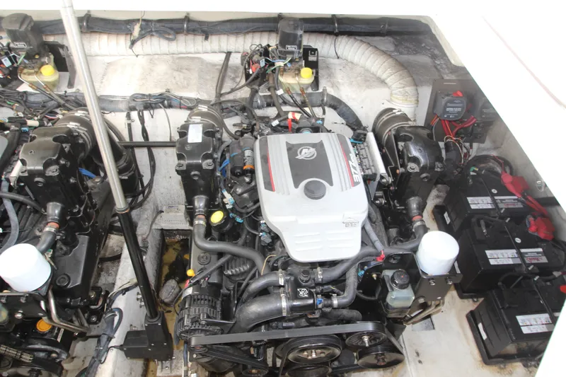 Slide: The Image of Engine compartment of a 2008 Rinker 330 Express Cruiser with visible components and batteries. - 46