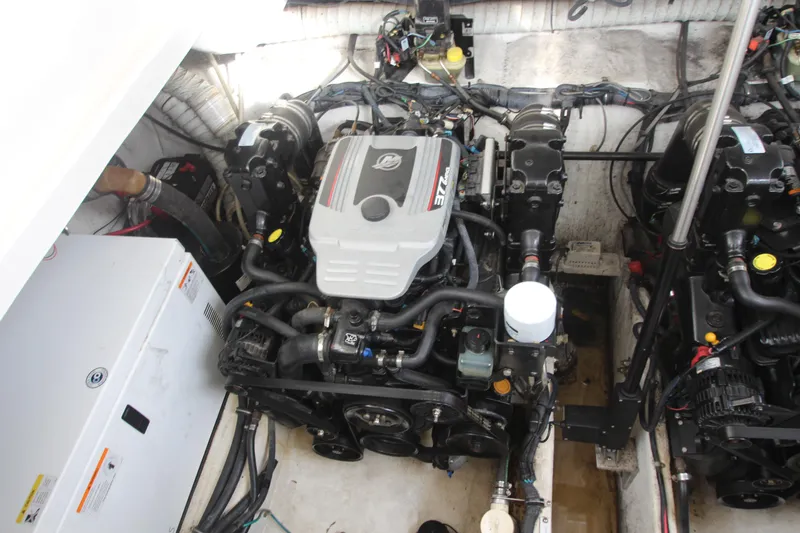 Slide: The Image of Engine compartment of 2008 Rinker 330 Express Cruiser, showcasing dual engines and mechanical components. - 47