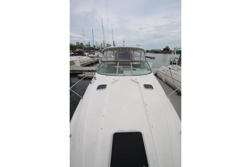 Slide: The Image of 2008 Rinker 330 Express Cruiser docked at marina, overcast sky. - 5