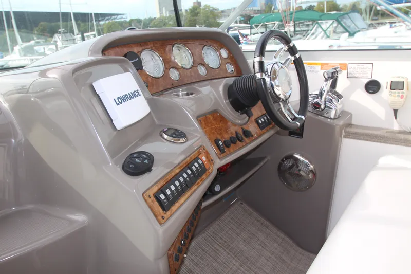 Slide: The Image of 2008 Rinker 330 Express Cruiser helm with steering wheel and control panel. - 50