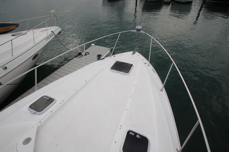 Slide: The Image of 2008 Rinker 330 Express Cruiser docked at marina, view from bow. - 6