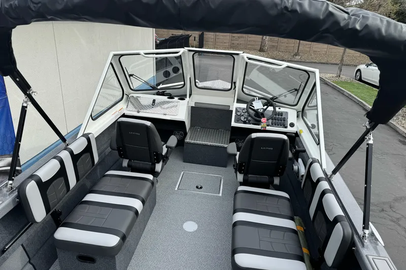 Slide: The Image of 2026 Lund 185 Heavy Gauge boat interior with seating and steering console. - 11