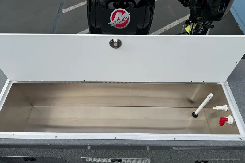 Slide: The Image of Open storage compartment in 2026 Lund 185 Heavy Gauge boat, featuring plumbing fixtures. - 15