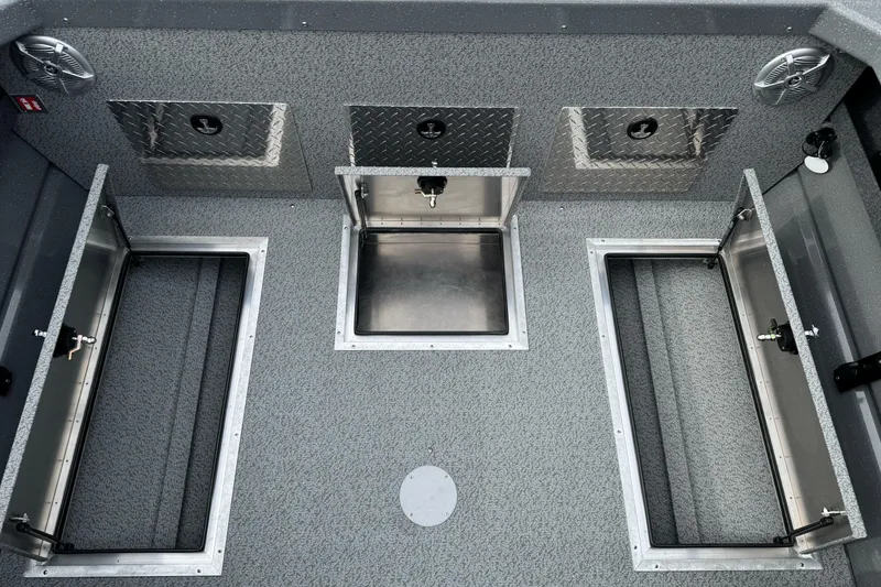 Slide: The Image of 2026 Lund 185 Heavy Gauge boat interior with storage compartments and diamond plate accents. - 19