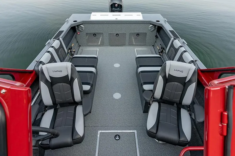 The Image of 2026 Lund 185 Heavy Gauge boat on trailer, parked outside a marine store. - 2