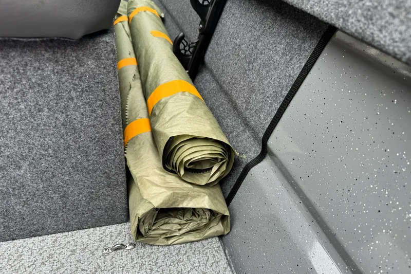 Slide: The Image of Rolled tarp stored in 2026 Lund 185 Heavy Gauge boat interior. - 23