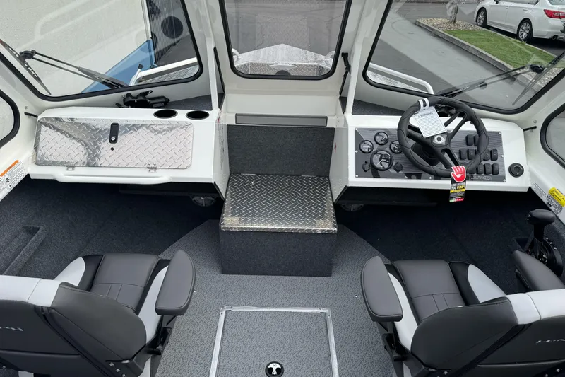 Slide: The Image of 2026 Lund 185 Heavy Gauge boat interior with steering wheel and seating. - 24