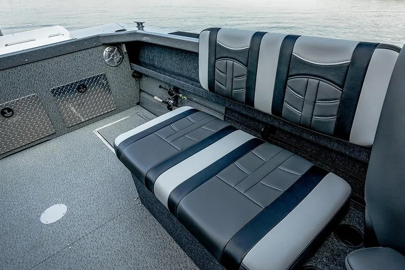 Slide: The Image of 2026 Lund 185 Heavy Gauge boat on trailer, parked outside a fishing store. - 4