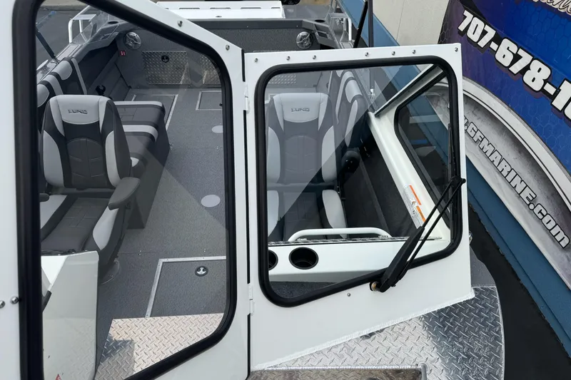 Slide: The Image of 2026 Lund 185 Heavy Gauge boat interior with modern seating and windshield view. - 40