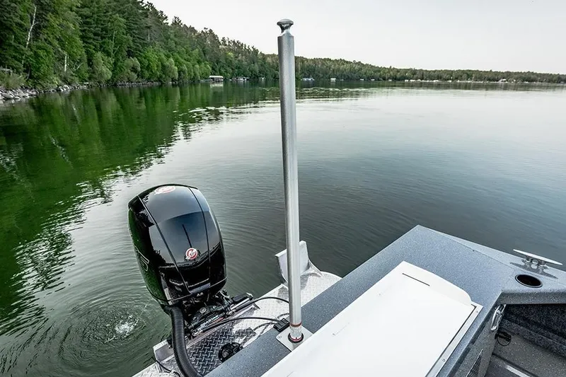 Slide: The Image of 2026 Lund 185 Heavy Gauge boat with dual outboard motors on a trailer. - 6