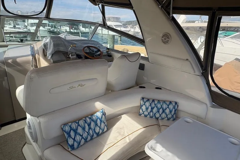 Slide: The Image of Interior of 2000 Sea Ray 310 Sundancer boat with white seating and blue cushions. - 10