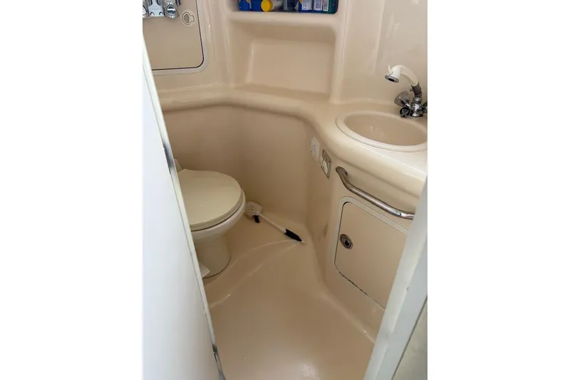 Slide: The Image of 2000 Sea Ray 310 Sundancer bathroom with toilet and sink. - 11