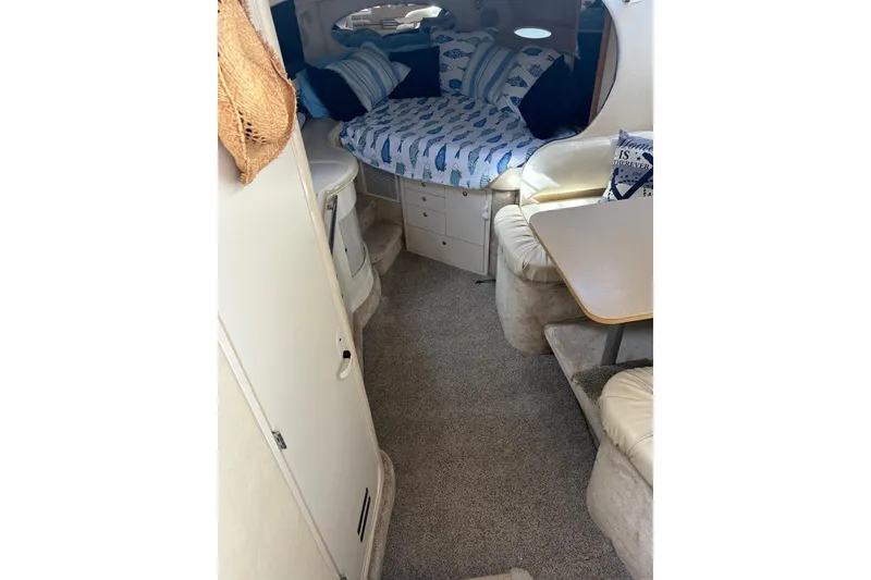 Slide: The Image of Interior of 2000 Sea Ray 310 Sundancer with cozy bed and seating area. - 16
