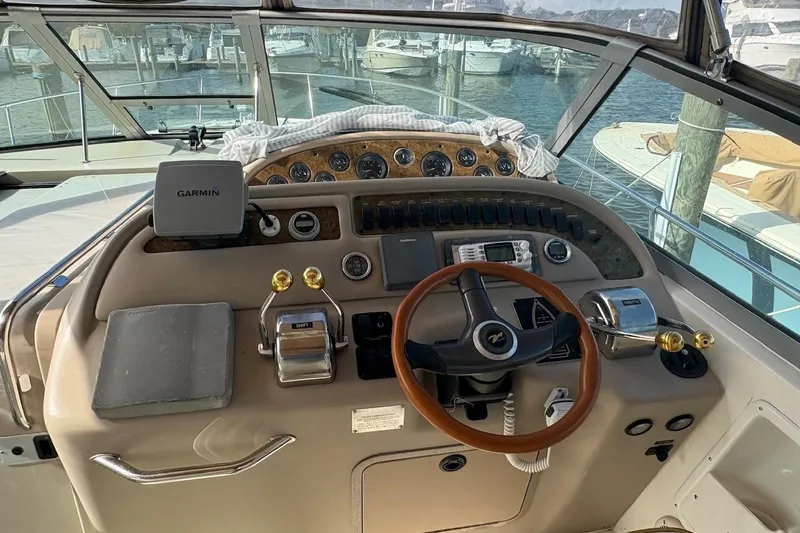 Slide: The Image of Cockpit of 2000 Sea Ray 310 Sundancer with Garmin navigation system and wooden steering wheel. - 4