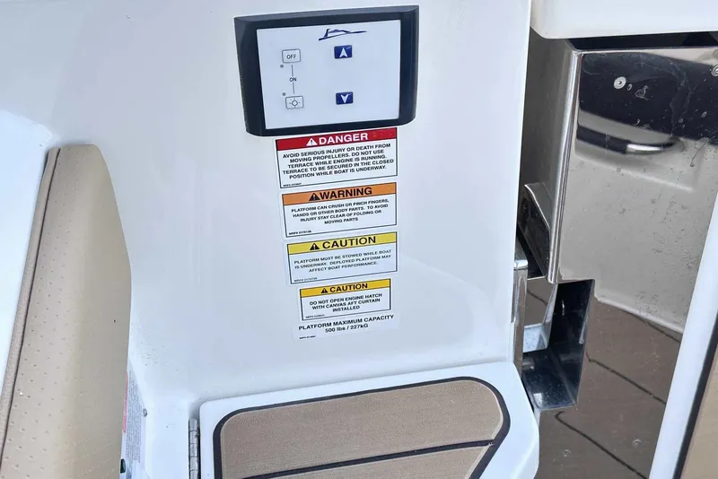 Slide: The Image of Control panel and safety warnings on 2024 Sea Ray SLX 400 boat. - 11