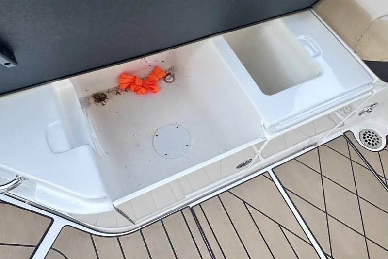 Slide: The Image of 2024 Sea Ray SLX 400 boat deck with storage compartment and orange item. - 15