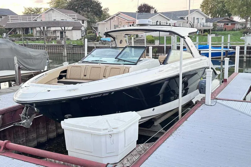 Slide: The Image of 2024 Sea Ray SLX 400 boat docked in a residential marina setting. - 2