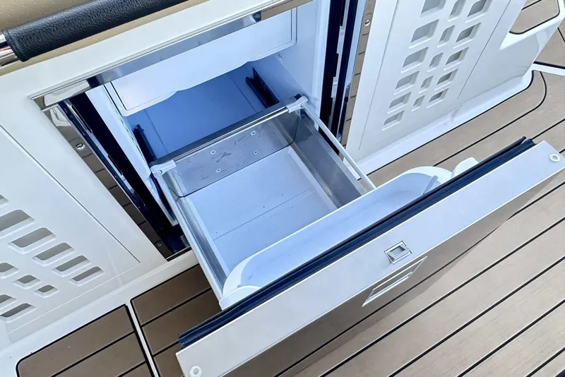 Slide: The Image of 2024 Sea Ray SLX 400 boat with open storage compartment on deck. - 20