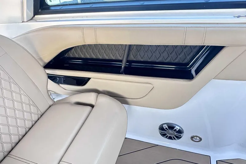Slide: The Image of 2024 Sea Ray SLX 400 interior with beige leather seating and diamond stitching. - 24