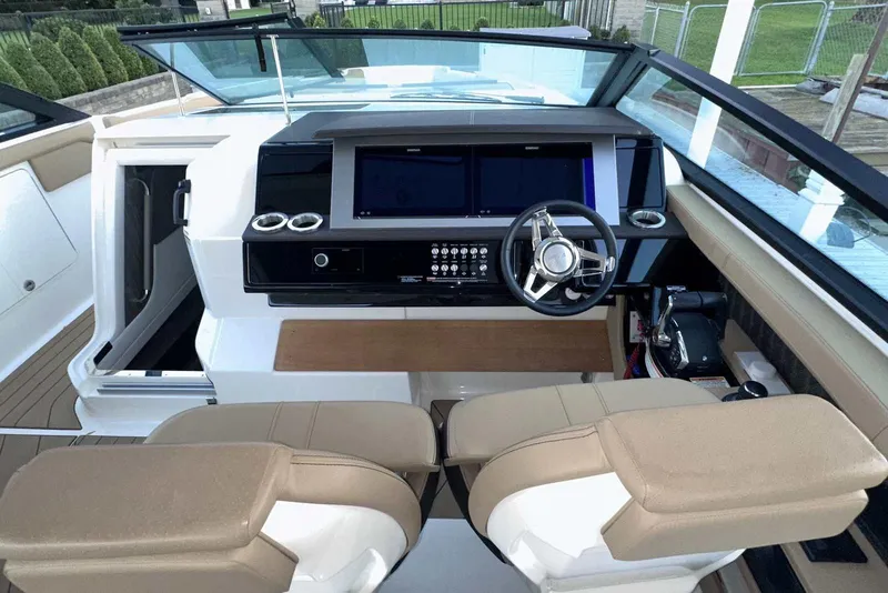Slide: The Image of 2024 Sea Ray SLX 400 helm with modern dashboard and dual seating. - 27