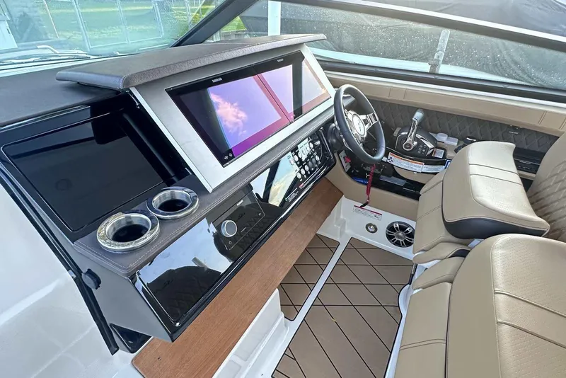 Slide: The Image of 2024 Sea Ray SLX 400 helm with modern controls, touchscreen display, and luxurious seating. - 28