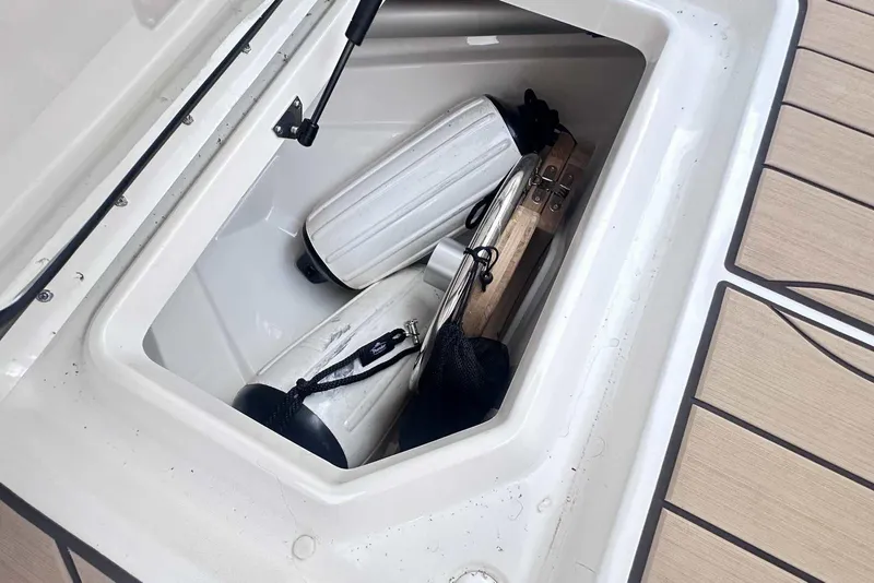 Slide: The Image of Storage compartment on 2024 Sea Ray SLX 400 boat with fenders and equipment. - 36