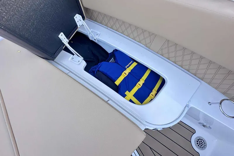 Slide: The Image of 2024 Sea Ray SLX 400 storage compartment with life jacket inside. - 38