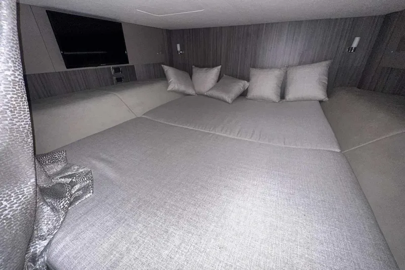 Slide: The Image of Luxurious cabin interior of 2024 Sea Ray SLX 400 with plush bedding and modern decor. - 49