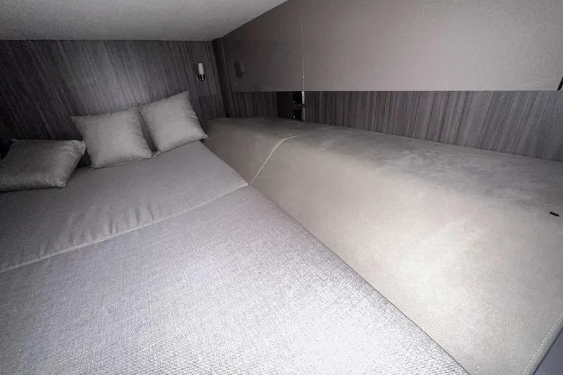 Slide: The Image of 2024 Sea Ray SLX 400 cabin interior with comfortable bedding and modern design. - 50