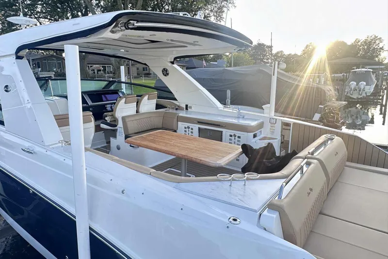 Slide: The Image of 2024 Sea Ray SLX 400 luxury boat with spacious seating and elegant design at sunset. - 6