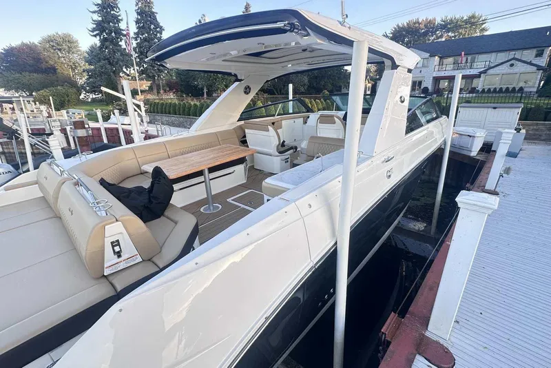 Slide: The Image of 2024 Sea Ray SLX 400 luxury boat docked, featuring spacious seating and elegant design. - 7