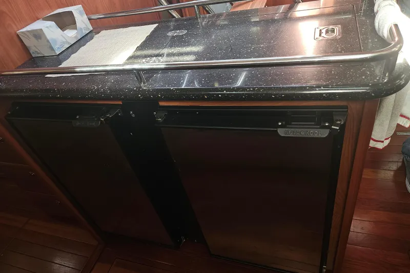 Slide: The Image of Interior of 2013 Marlow-Hunter 50 aft cabin with TV and wood paneling. - 23