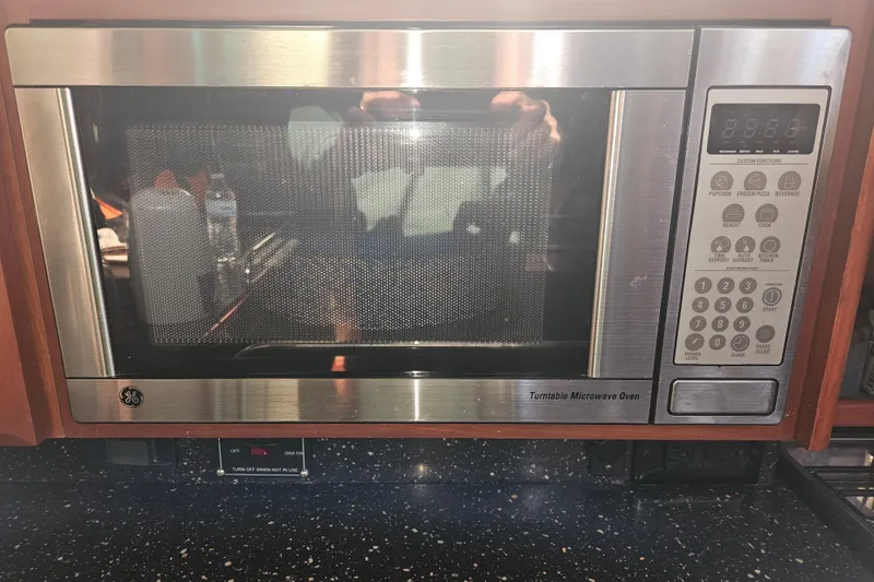 Slide: The Image of Wooden interior of 2013 Marlow-Hunter 50 aft cabin with decorative cabinet and colorful flags. - 24