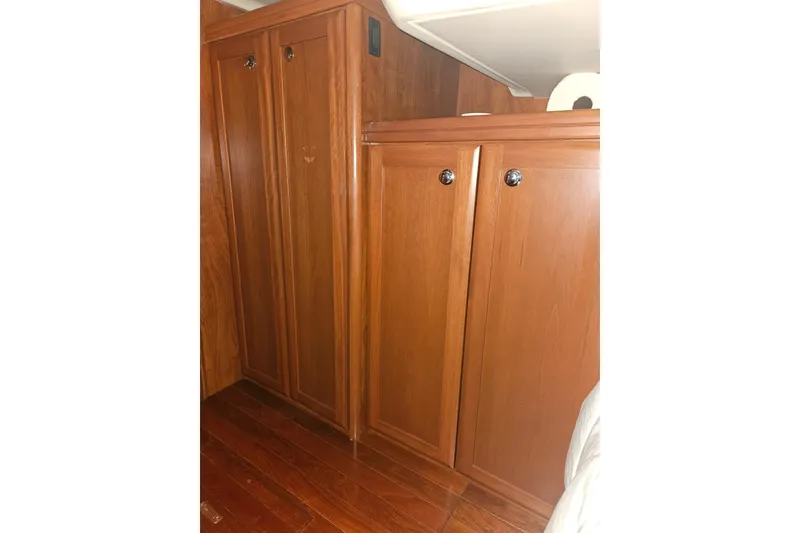 Slide: The Image of Wooden interior of 2013 Marlow-Hunter 50 aft cabin, featuring cabinetry and seating. - 37