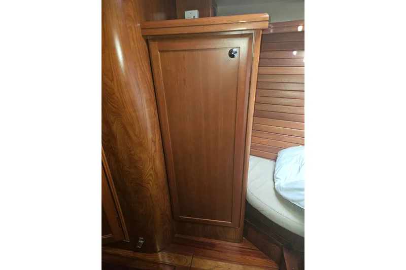 Slide: The Image of 2013 Marlow-Hunter 50 aft cabin bathroom with sink, toilet, and toiletries. - 40