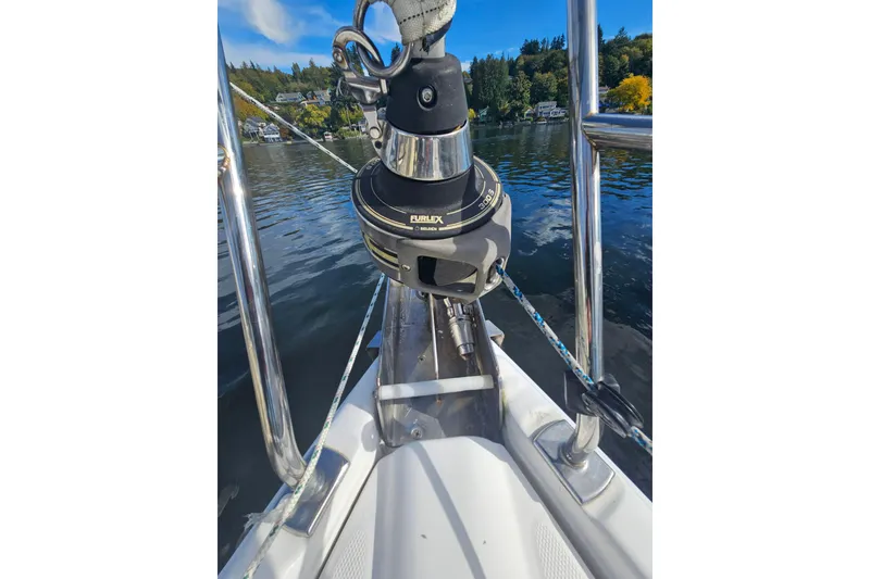 Slide: The Image of 2013 Marlow-Hunter 50 aft cabin sailboat bow with furler, on calm water. - 59