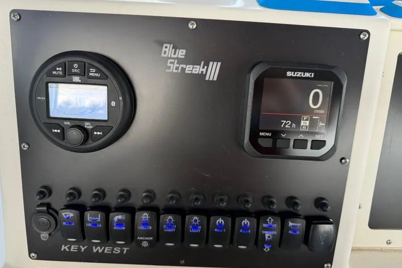 Slide: The Image of Control panel of a 2001 Key West 2300 Center Console boat with Suzuki display. - 13