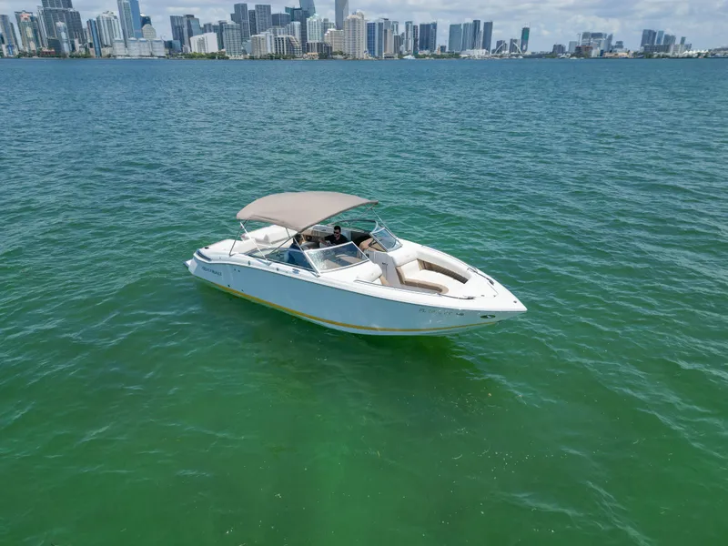 Slide: The Image of 2013 Cobalt 296 boat on water with city skyline in background. - 5