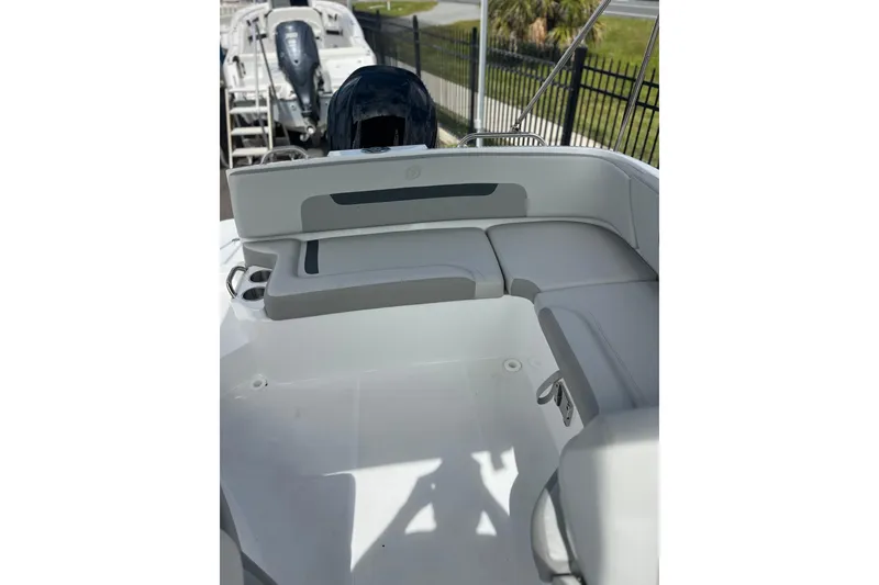 Slide: The Image of 2026 Hurricane SunDeck 235 OB boat interior with cushioned seating and sleek design. - 14