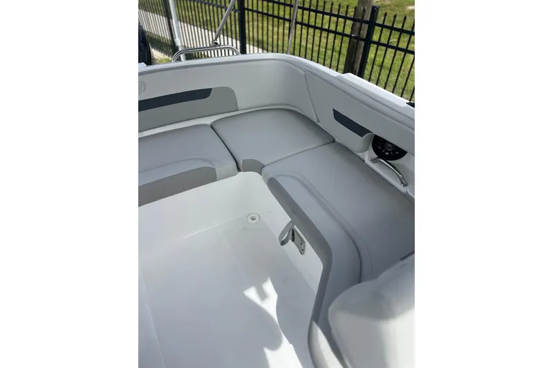 Slide: The Image of 2026 Hurricane SunDeck 235 OB boat interior with gray seating and sleek design. - 15