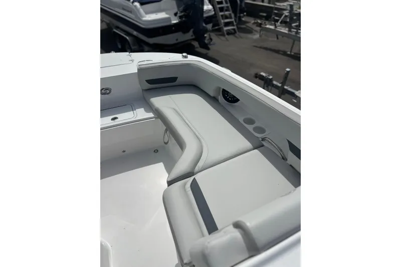 Slide: The Image of 2026 Hurricane SunDeck 235 OB boat interior with cushioned seating and cup holders. - 7