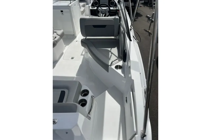 Slide: The Image of 2026 Hurricane SunDeck 235 OB boat interior with seating and cup holders. - 9