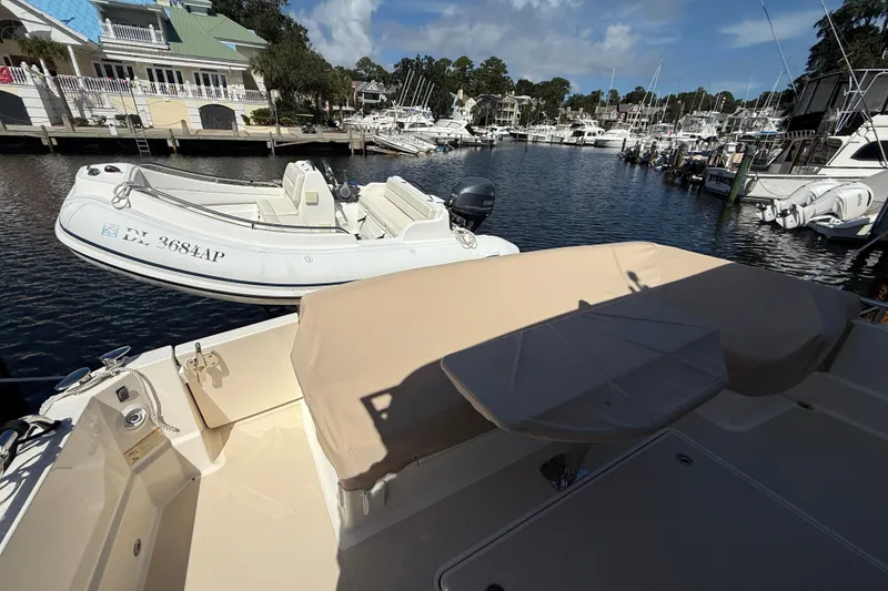 Slide: The Image of 2023 Sabre 43 Salon Express yacht docked with inflatable boat in marina. - 15