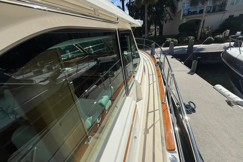 Slide: The Image of 2023 Sabre 43 Salon Express yacht docked, showcasing sleek design and polished wood accents. - 19