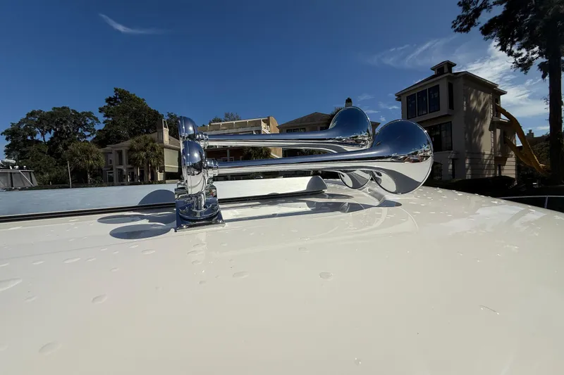 Slide: The Image of Chrome horns on 2023 Sabre 43 Salon Express yacht, sunny day, residential backdrop. - 22
